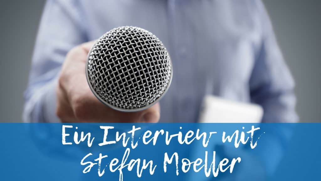Man with microphone behind writing: An interview with Stefan Moeller