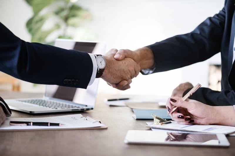 Selling a company: Two people shake hands